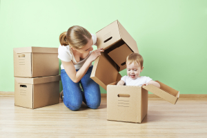 happy family mother and baby daughter in an empty apartment with
