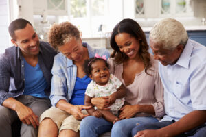 Grandparents, parents and a happy baby girl on mumâs knee